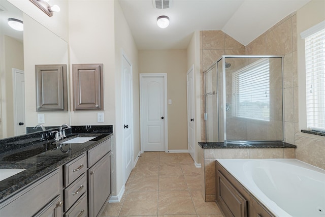 full bath with a garden tub, a sink, plenty of natural light, and a shower stall