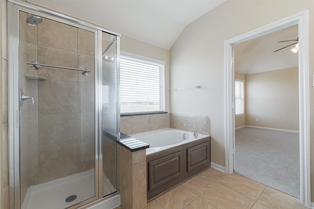 bathroom featuring tile patterned floors, a shower stall, a bath, and lofted ceiling