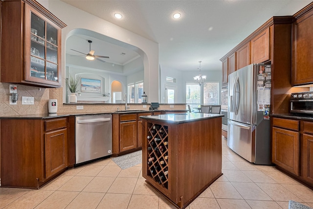 26210 Seminole Hill Ln, Katy, TX 77494 - kitchen featuring stainless steel appliances, a sink, dark countertops, a center island, and recessed lighting