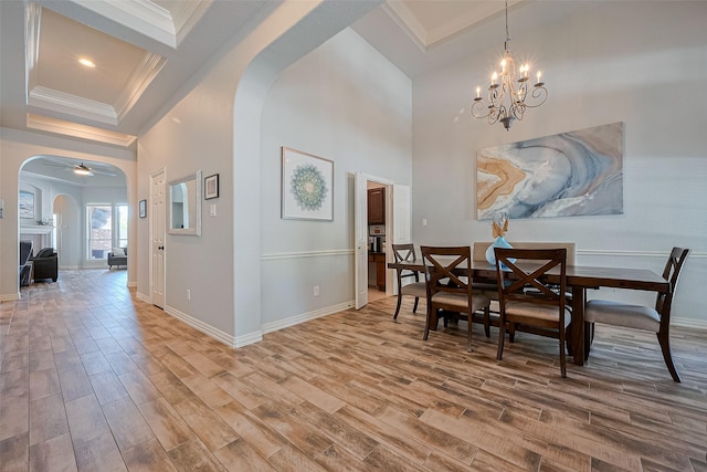 26210 Seminole Hill Ln, Katy, TX 77494 - dining area featuring arched walkways, ornamental molding, wood finished floors, baseboards, and a chandelier