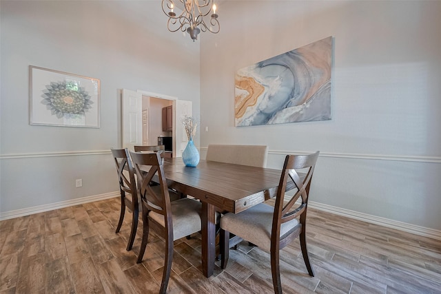 26210 Seminole Hill Ln, Katy, TX 77494 - dining area with wood finished floors, a chandelier, baseboards, and a towering ceiling