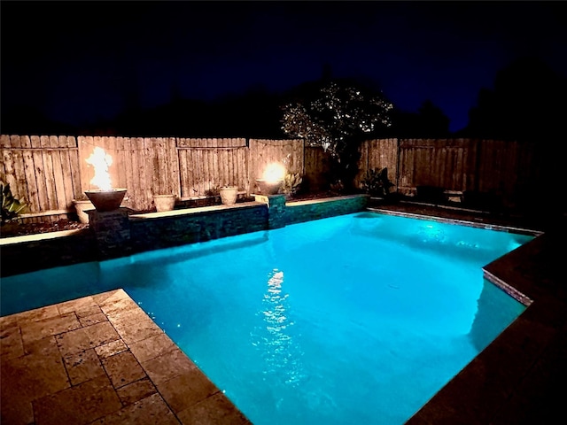 26210 Seminole Hill Ln, Katy, TX 77494 - pool at twilight featuring a fenced backyard