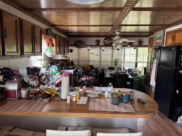 kitchen with freestanding refrigerator, wood ceiling, ceiling fan, and brown cabinets