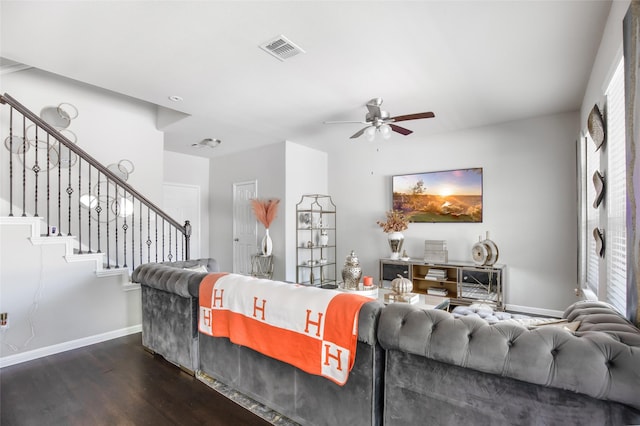 living area featuring a ceiling fan, visible vents, wood finished floors, stairway, and baseboards