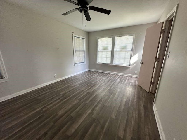 810 E Bowie Ave, Harlingen, TX 78550 - unfurnished room featuring dark wood-style flooring, baseboards, and ceiling fan