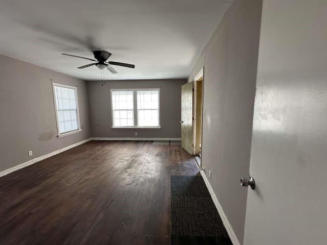 810 E Bowie Ave, Harlingen, TX 78550 - unfurnished room featuring a ceiling fan, baseboards, and dark wood-style floors