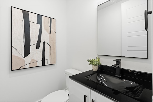 half bath with vanity and toilet