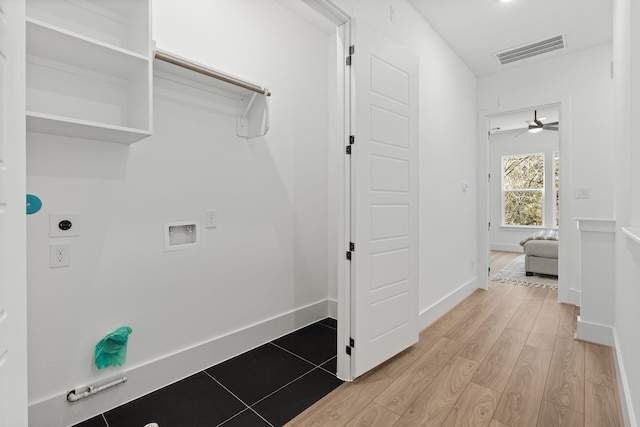 clothes washing area with visible vents, baseboards, electric dryer hookup, light wood-style flooring, and washer hookup
