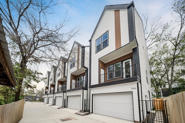view of home's exterior featuring fence, driveway, and a garage