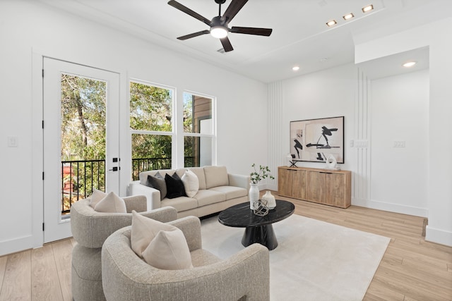 living area featuring a ceiling fan, baseboards, recessed lighting, and light wood finished floors