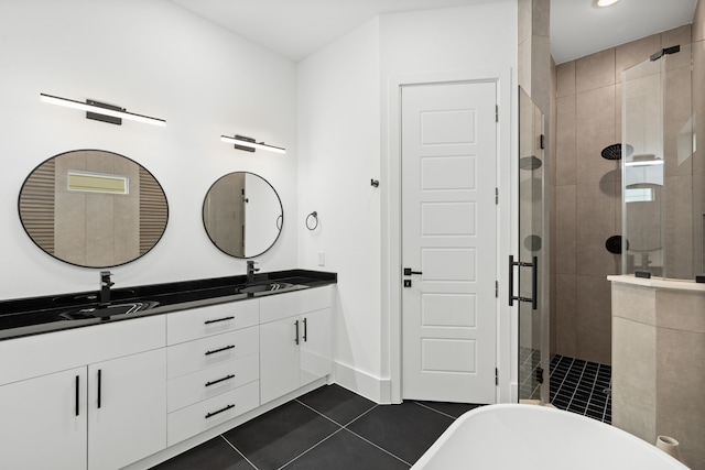 bathroom featuring a sink, tile patterned flooring, a stall shower, and double vanity