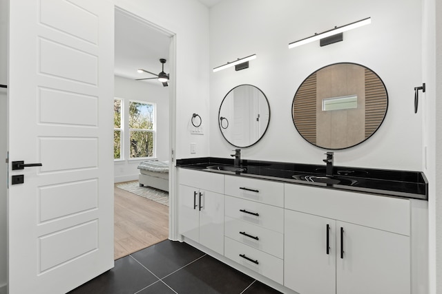 full bath featuring double vanity, a ceiling fan, tile patterned floors, and a sink