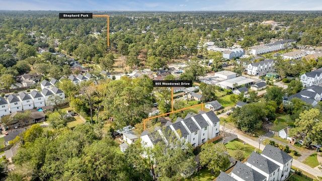 drone / aerial view featuring a residential view and a view of trees
