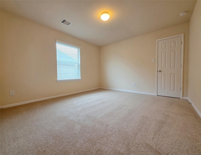 unfurnished room featuring visible vents, baseboards, and carpet floors