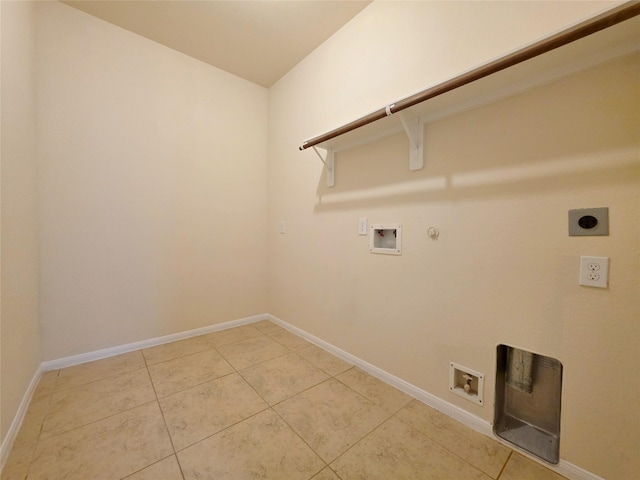 clothes washing area with laundry area, baseboards, gas dryer hookup, electric dryer hookup, and washer hookup