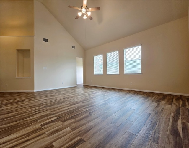 spare room with visible vents, dark wood-style flooring, baseboards, high vaulted ceiling, and a ceiling fan