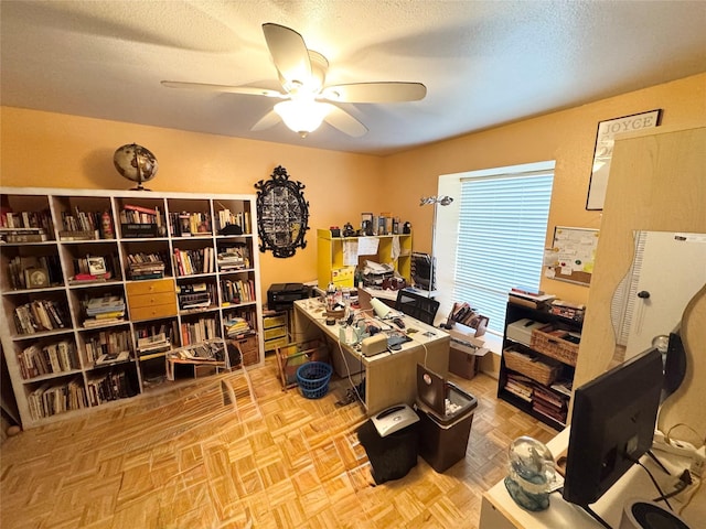 office space with a textured ceiling and ceiling fan