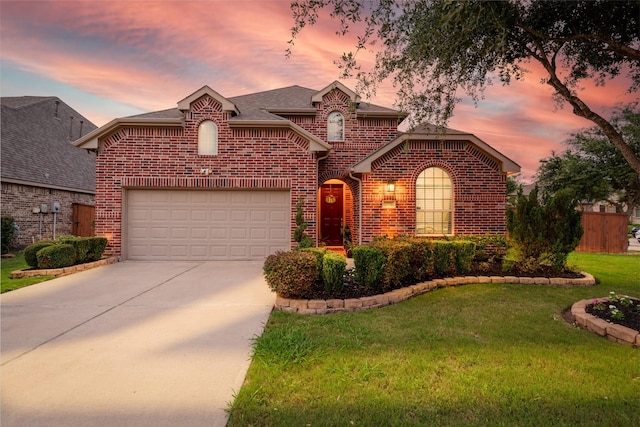 17014 Wellinghoff Ct, Richmond, TX 77407 - view of front of home with brick siding, driveway, a yard, and a garage