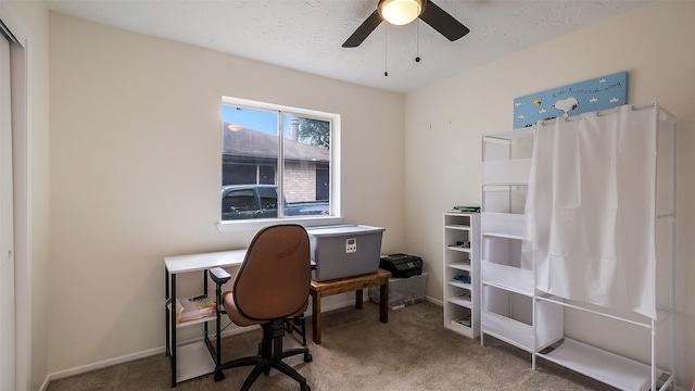 office area featuring carpet floors, ceiling fan, and baseboards