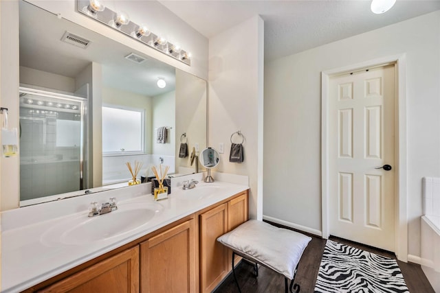 15334 Forest Creek Farms Dr, Cypress, TX 77429 - full bathroom with wood finished floors, double vanity, and a shower with door