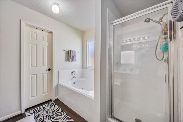 15334 Forest Creek Farms Dr, Cypress, TX 77429 - full bath featuring a stall shower, a jetted tub, and wood finished floors