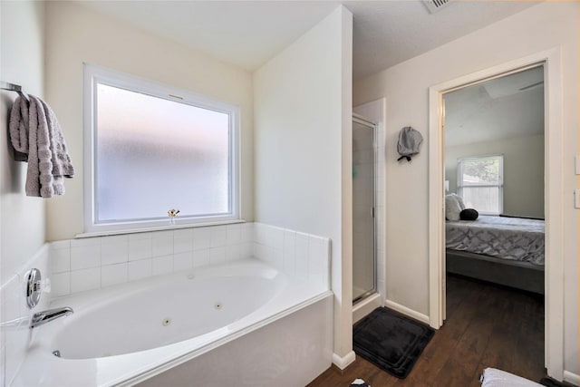 15334 Forest Creek Farms Dr, Cypress, TX 77429 - bathroom featuring ensuite bath, a shower stall, wood-type flooring, and a whirlpool tub