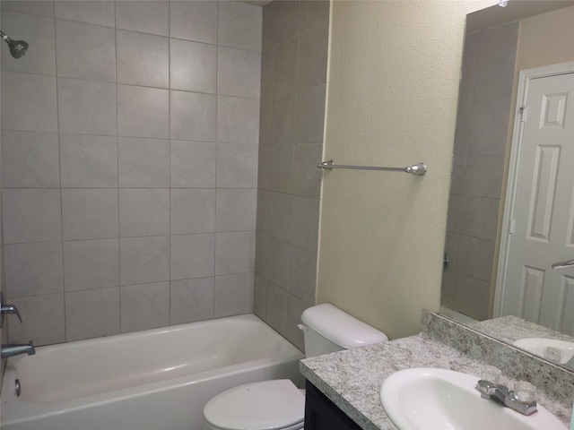 bathroom featuring toilet, washtub / shower combination, and vanity