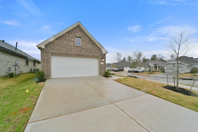 1642 Portia Ln, Conroe, TX 77301 - view of front of home featuring a garage, a residential view, a front lawn, and brick siding