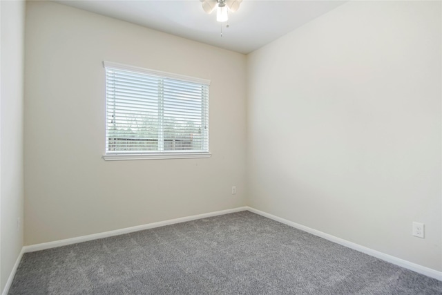 empty room with carpet floors, a ceiling fan, and baseboards