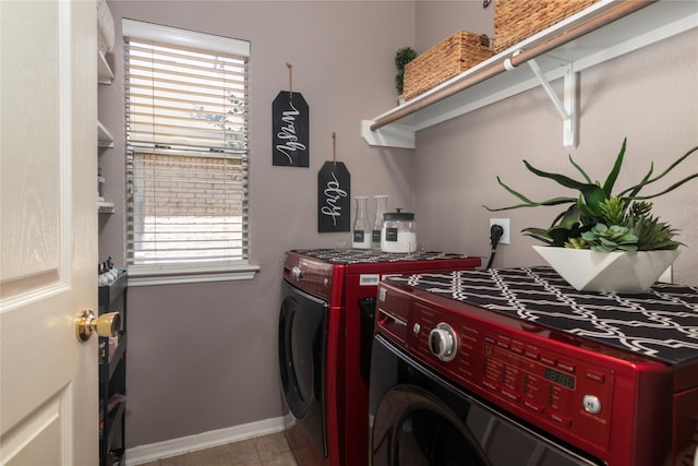 laundry area with separate washer and dryer, laundry area, light tile patterned floors, and baseboards