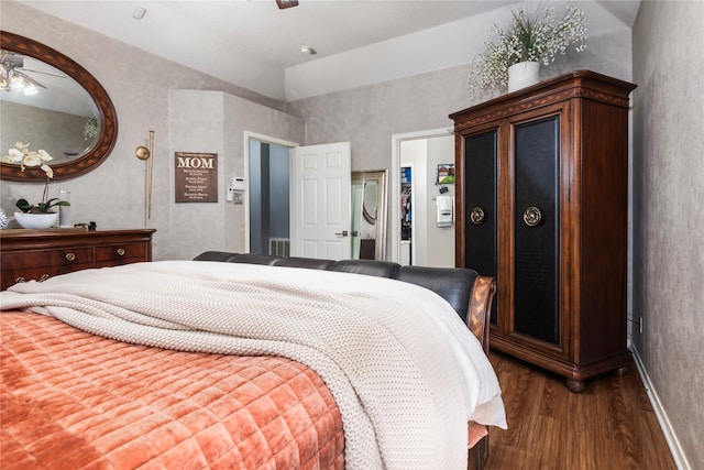 bedroom featuring lofted ceiling and wood finished floors