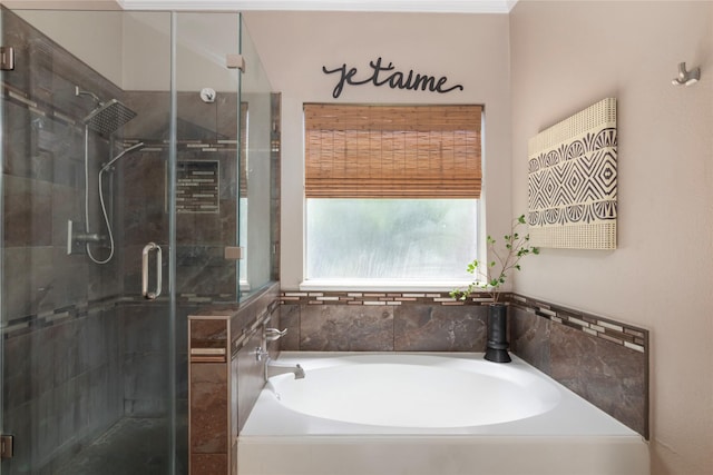 bathroom featuring a garden tub and a shower stall
