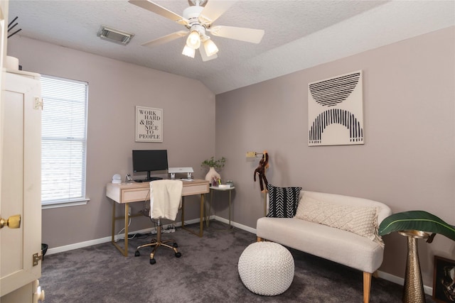 carpeted office with a textured ceiling, baseboards, a ceiling fan, and visible vents
