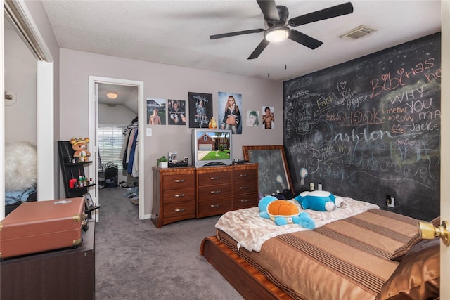 carpeted bedroom with ceiling fan, a spacious closet, a closet, and visible vents