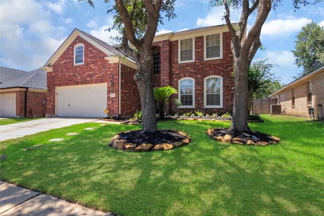 traditional-style home featuring a garage, fence, a front lawn, brick siding, and driveway