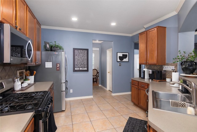 kitchen with light countertops, stainless steel appliances, tasteful backsplash, and a sink