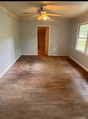 unfurnished room featuring baseboards, ceiling fan, crown molding, and wood finished floors