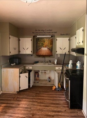 kitchen with a sink, dark wood-style flooring, white cabinetry, and stainless steel range with electric stovetop