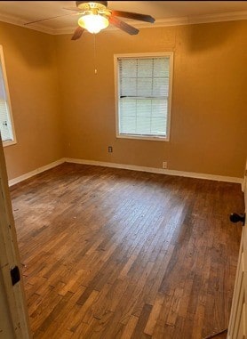 unfurnished room with dark wood-type flooring, ornamental molding, baseboards, and ceiling fan