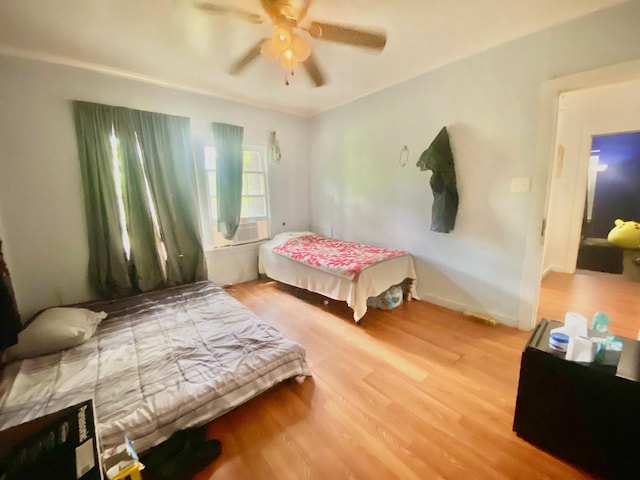 bedroom featuring a ceiling fan and wood finished floors