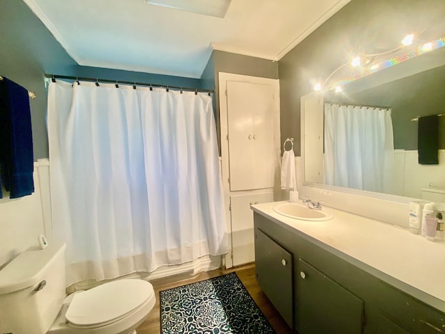 full bath featuring vanity, ornamental molding, wood finished floors, toilet, and shower / tub combo