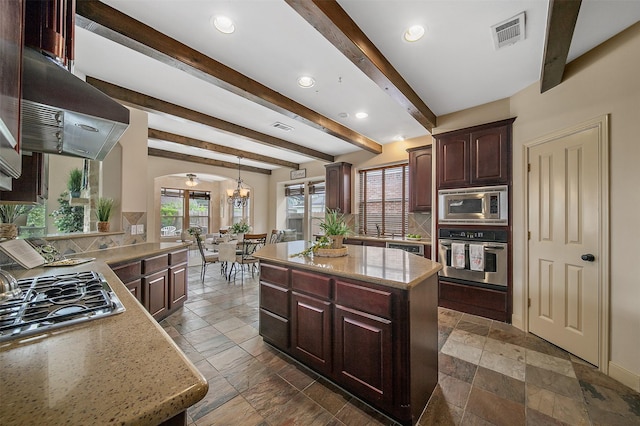 kitchen featuring visible vents, stone tile flooring, tasteful backsplash, arched walkways, and stainless steel appliances