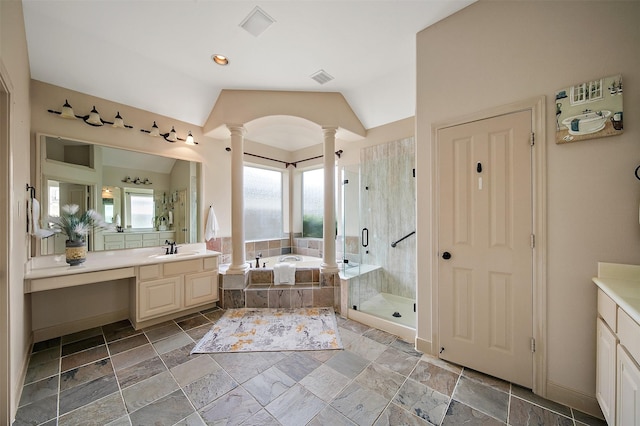 bathroom featuring vanity, decorative columns, a bath, and a stall shower