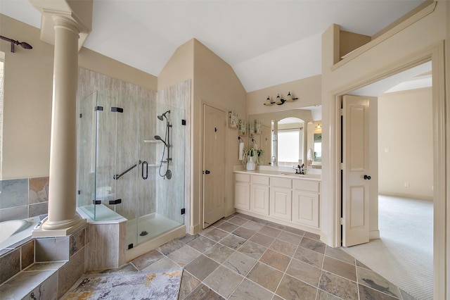 full bathroom featuring ornate columns, vanity, a garden tub, and a shower stall