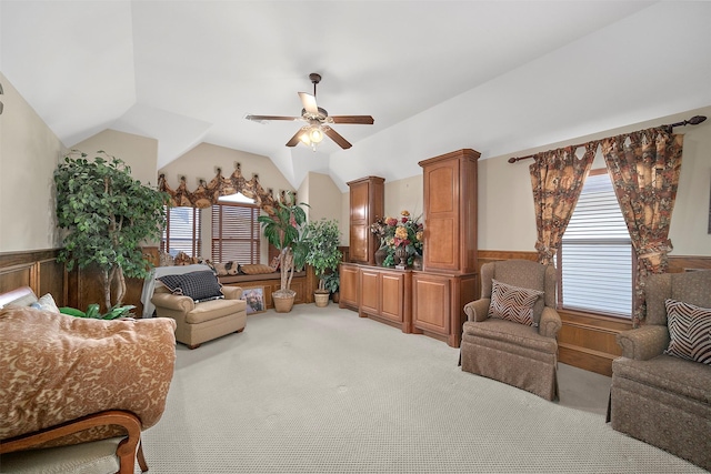 interior space featuring light colored carpet, wainscoting, ceiling fan, and vaulted ceiling