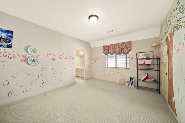 rec room with arched walkways, light carpet, and visible vents