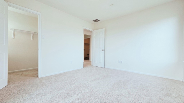 2702 Urban Glen Ct, Houston, TX 77038 - unfurnished bedroom with a spacious closet, carpet floors, baseboards, and a closet