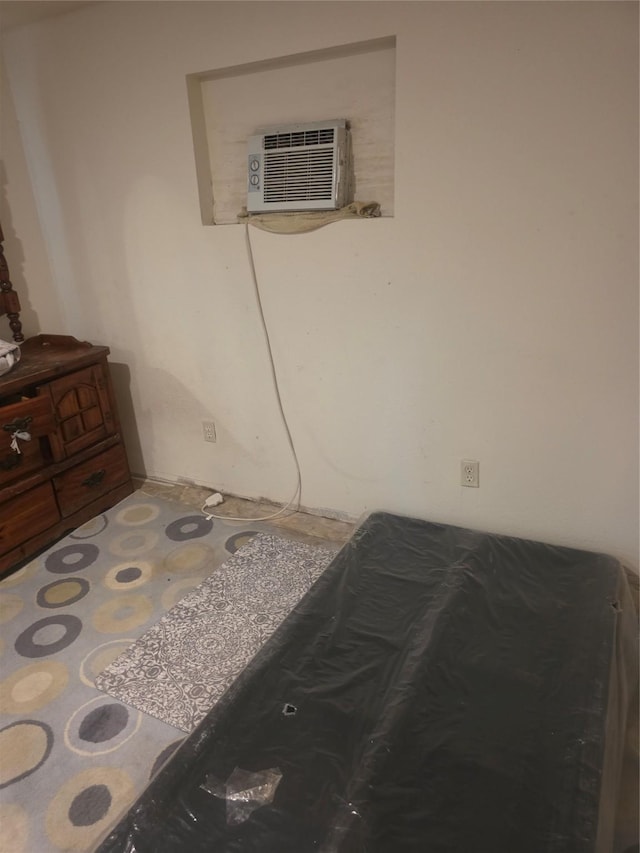 bedroom featuring a wall unit AC