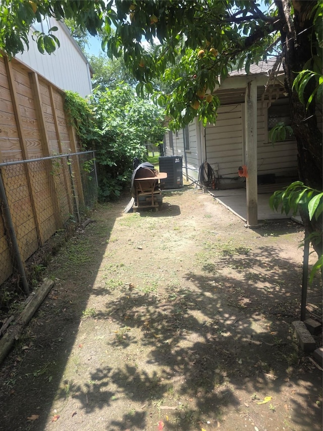 view of yard featuring fence, a patio, and cooling unit
