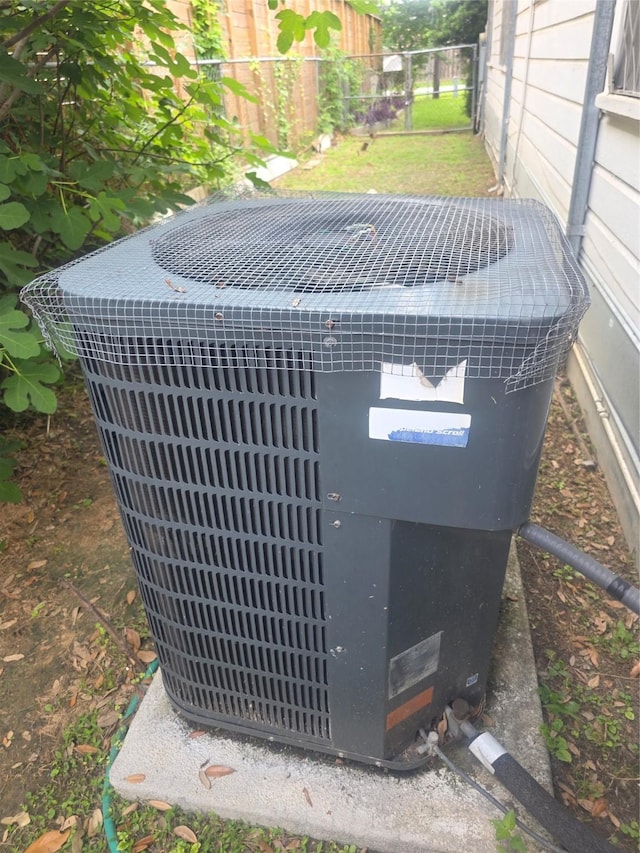 details featuring central air condition unit and fence